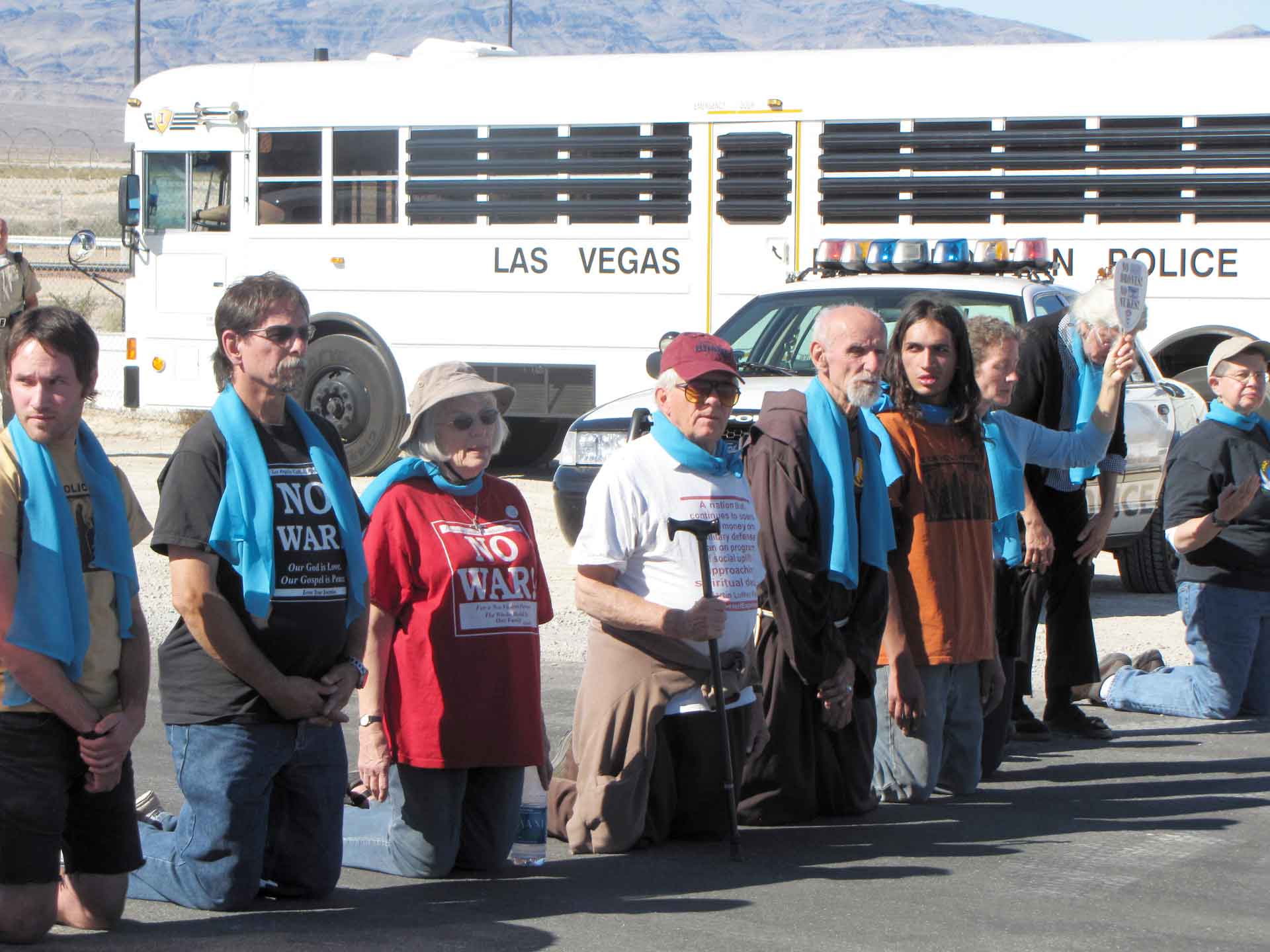 Part of group blocking Creech access road. Blue scarves signify solidarity with a campaign initiated by the Afghan Youth Peace Volunteers.