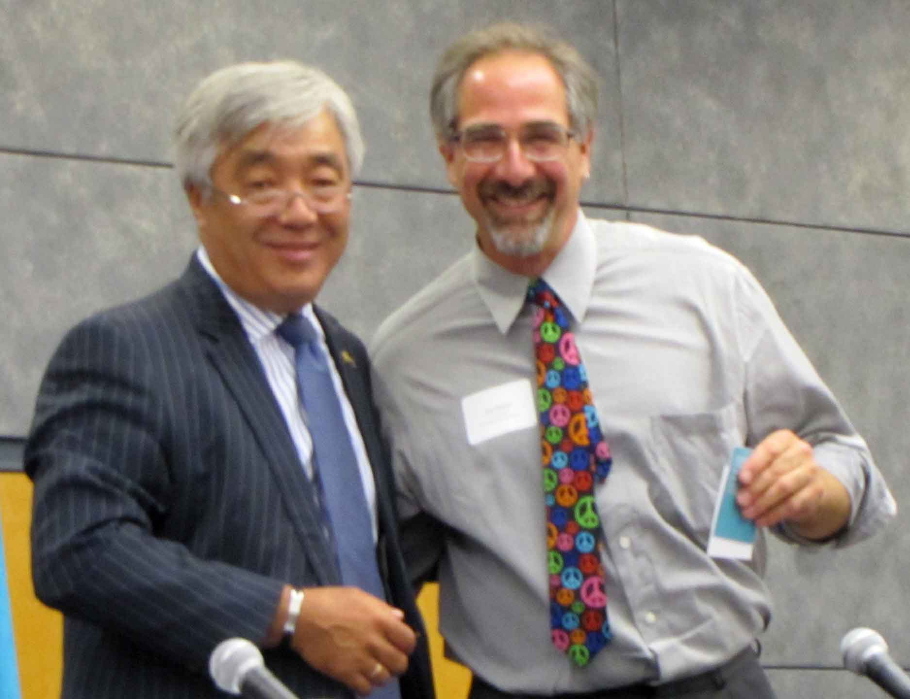 Kazakhstan Ambassador to the US, Erlan Idrissov, presents anti-nuclear testing medal to NDE's Jim Haber.