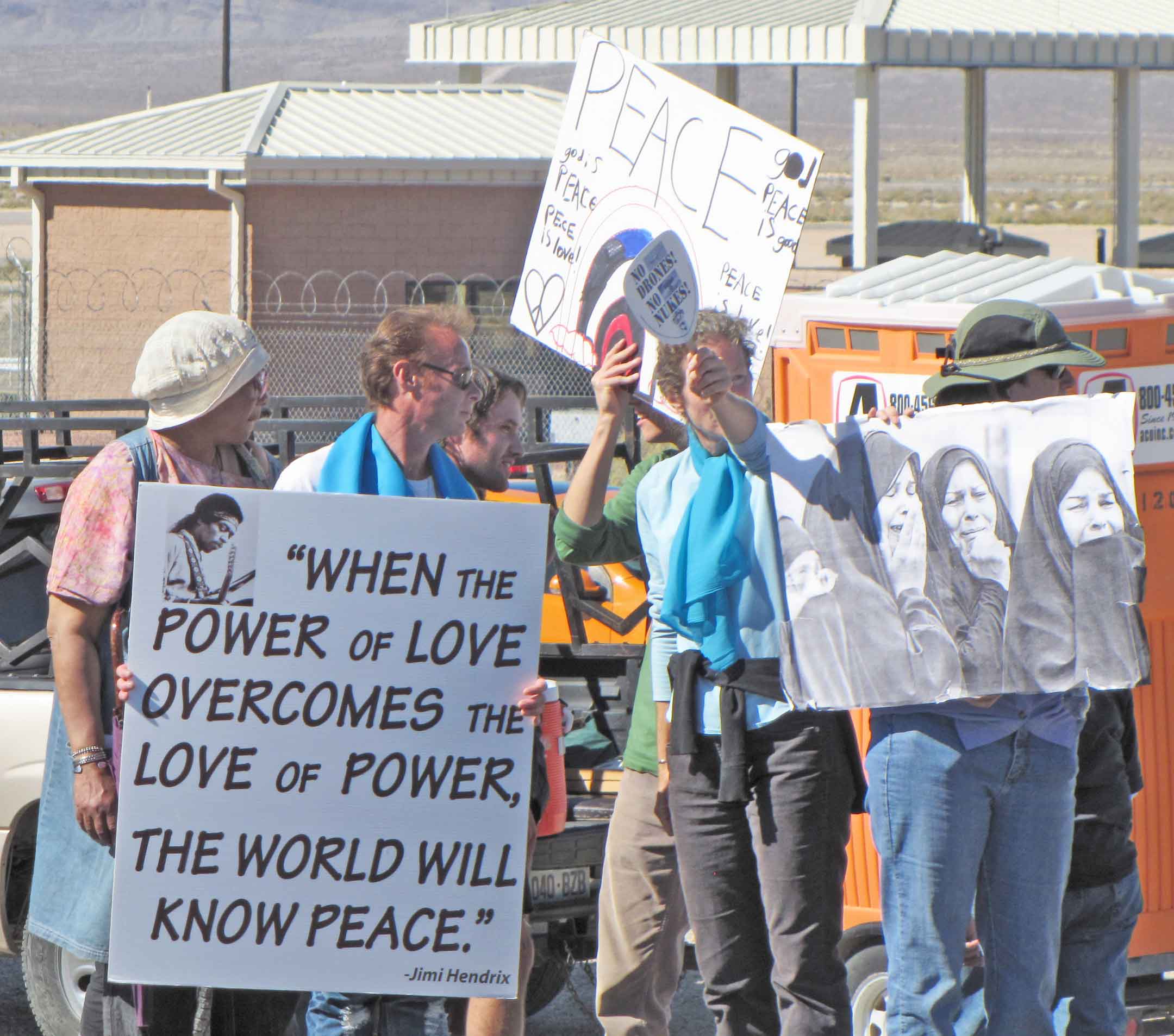 Signs of outrage, peace & mourning at Creech.